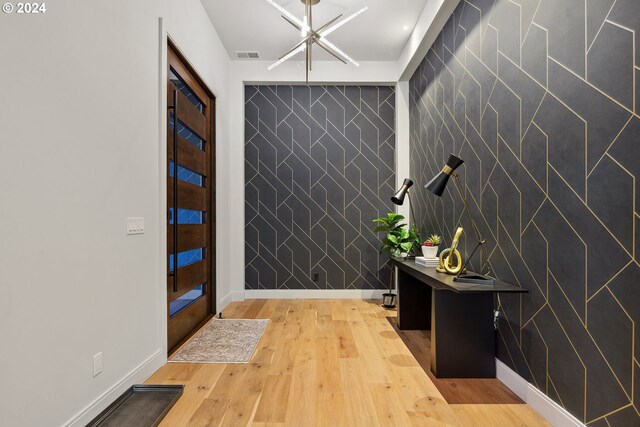 entrance foyer featuring hardwood / wood-style floors and tile walls