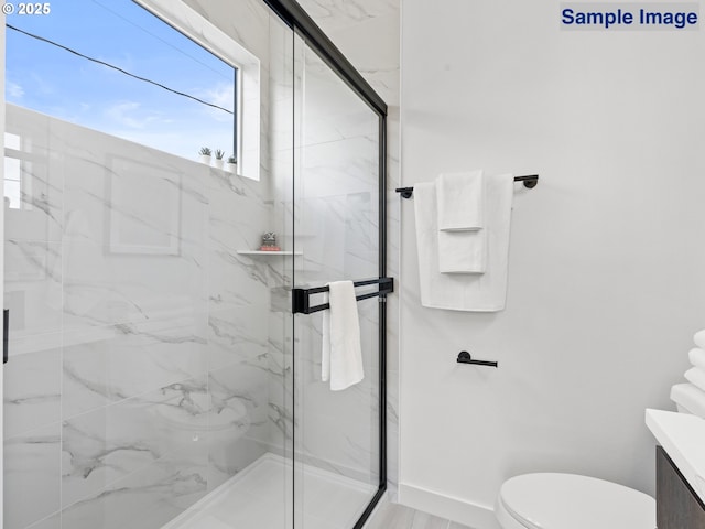 full bathroom with toilet, a marble finish shower, and baseboards