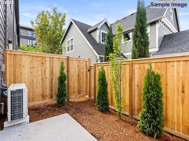 view of yard with fence, a patio area, and central AC