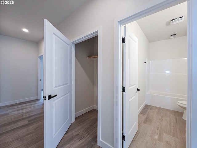 hallway with recessed lighting, baseboards, and wood finished floors