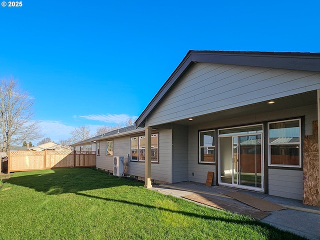 back of property featuring a patio area, a yard, and fence