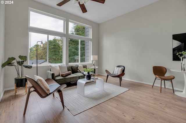 living room with ceiling fan, light hardwood / wood-style flooring, and a wealth of natural light