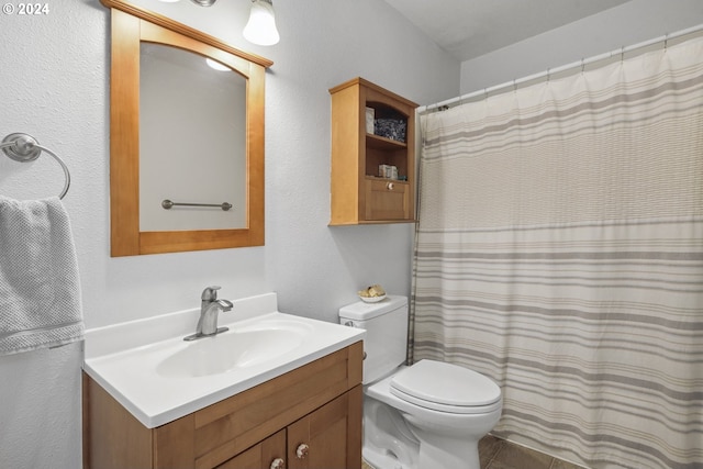 bathroom featuring vanity, curtained shower, and toilet