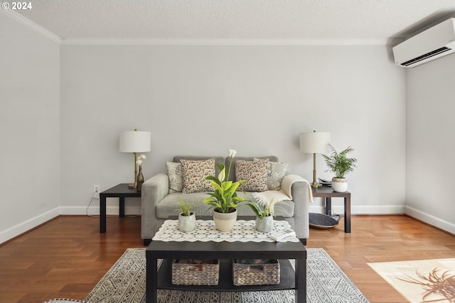 living area with ornamental molding, an AC wall unit, and hardwood / wood-style floors