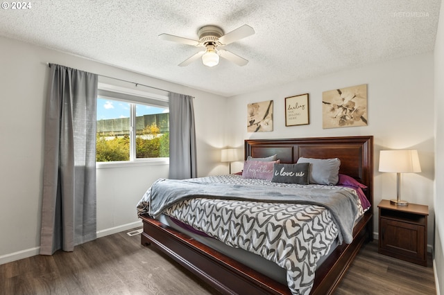 bedroom featuring dark hardwood / wood-style floors, a textured ceiling, and ceiling fan