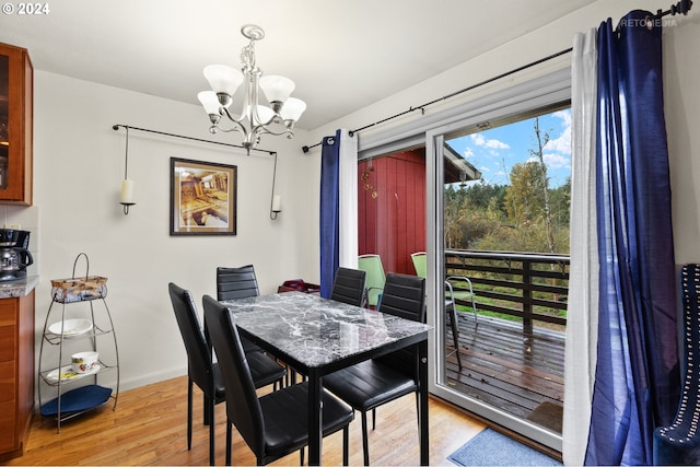 dining room featuring light hardwood / wood-style floors, an inviting chandelier, and plenty of natural light