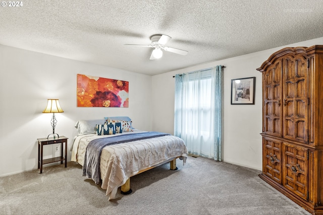 bedroom with ceiling fan, a textured ceiling, and light colored carpet