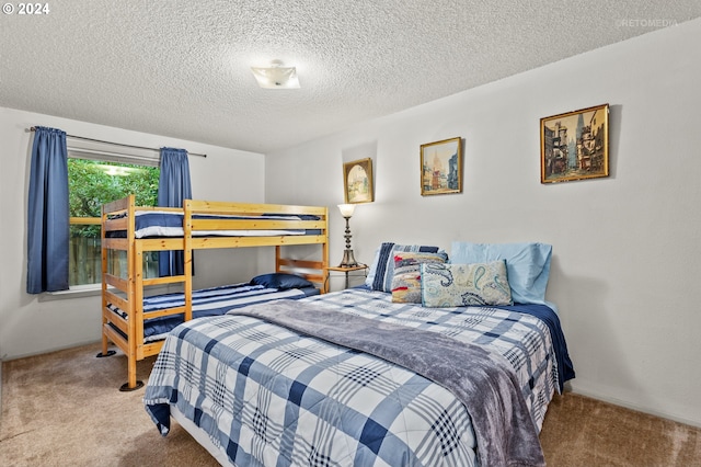 carpeted bedroom featuring a textured ceiling