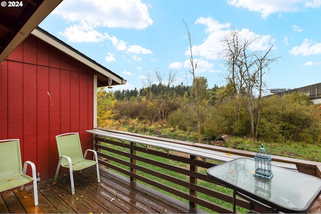 wooden deck featuring outdoor dining area