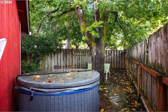exterior space featuring a fenced backyard and a hot tub