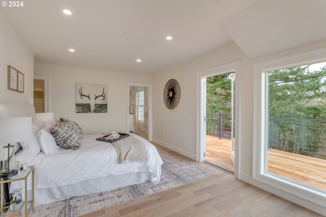 bedroom featuring light hardwood / wood-style floors and access to outside