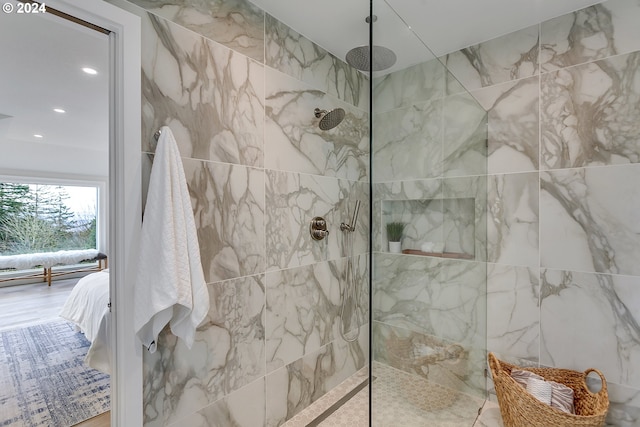 bathroom featuring a tile shower and tile walls