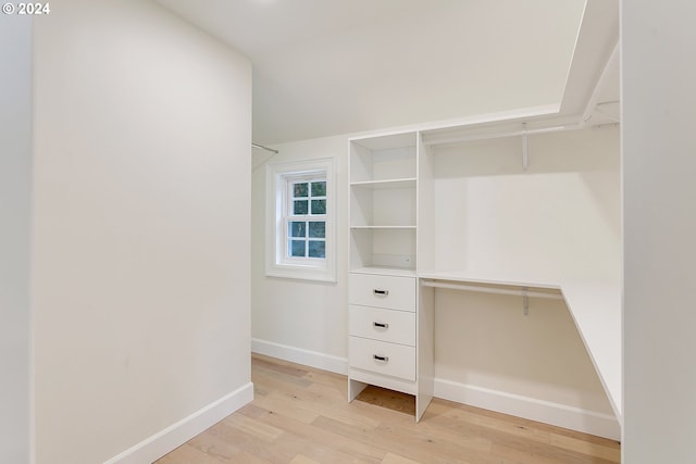 walk in closet featuring light hardwood / wood-style flooring