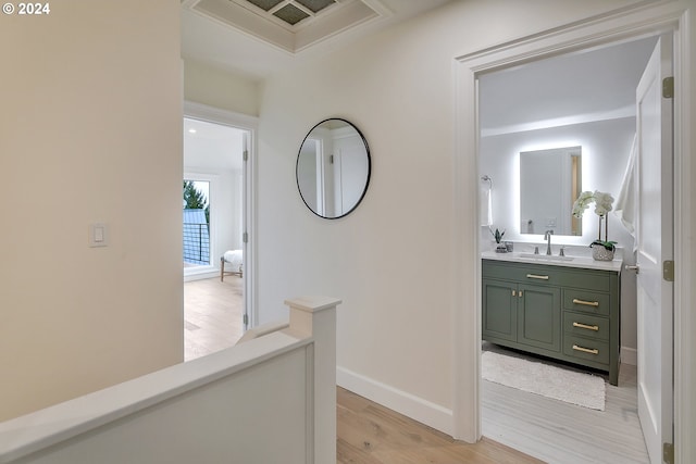 hall featuring light hardwood / wood-style floors and sink