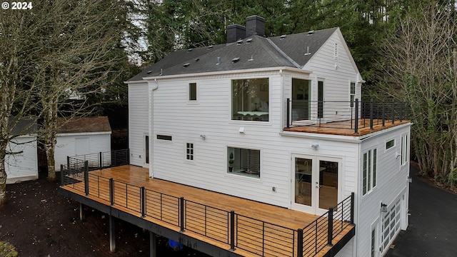 back of property featuring french doors, a balcony, and a deck