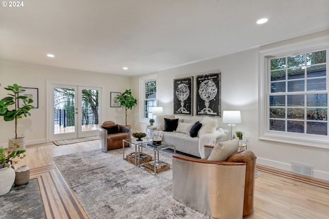 living room with french doors and light wood-type flooring