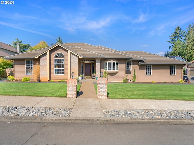 ranch-style house with a front lawn