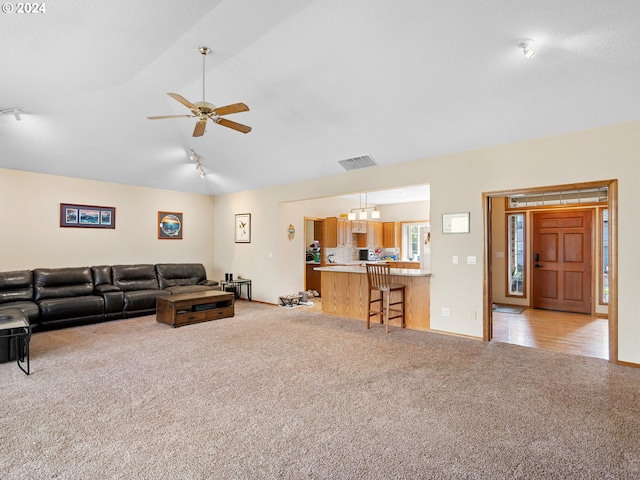 living room with ceiling fan, light colored carpet, vaulted ceiling, and rail lighting