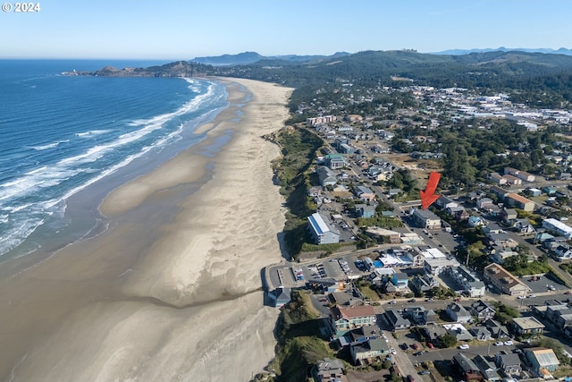 drone / aerial view featuring a water and mountain view and a view of the beach