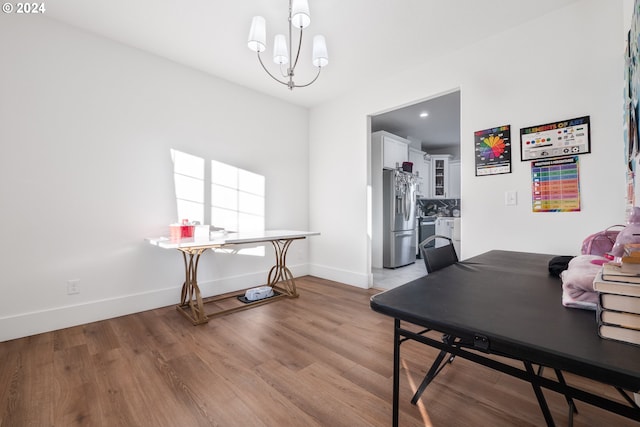 office area with a notable chandelier and light hardwood / wood-style floors