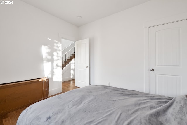 bedroom with hardwood / wood-style flooring