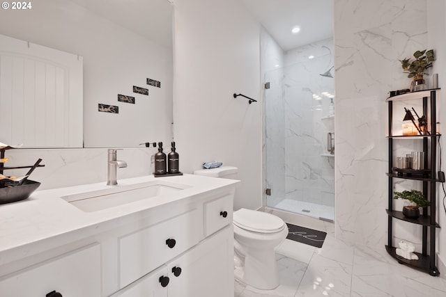 bathroom featuring vanity, toilet, and a shower with shower door