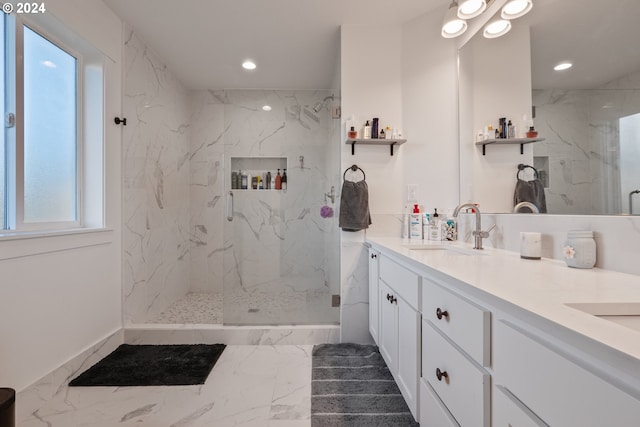 bathroom featuring a wealth of natural light, vanity, and an enclosed shower