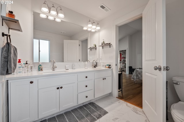 bathroom featuring hardwood / wood-style floors, vanity, and toilet