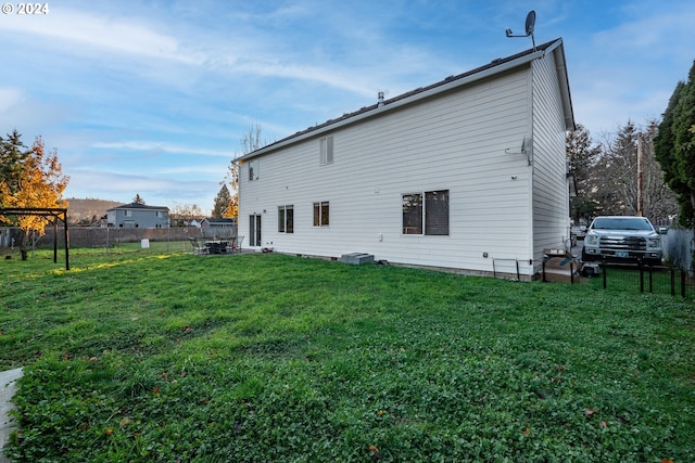 back of property featuring a lawn