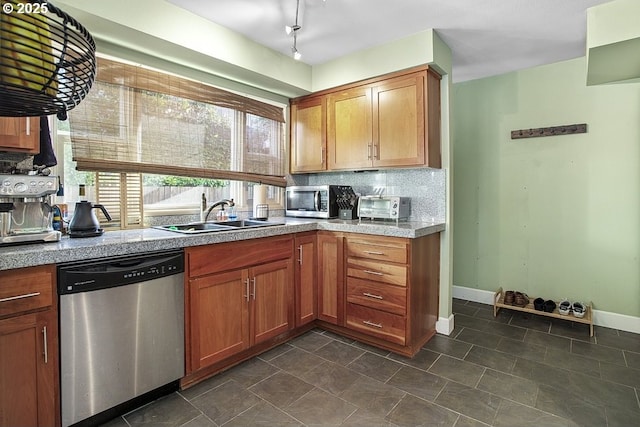 kitchen with backsplash, sink, and appliances with stainless steel finishes