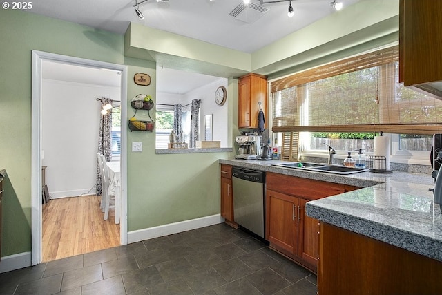 kitchen featuring stainless steel dishwasher, ornamental molding, and sink