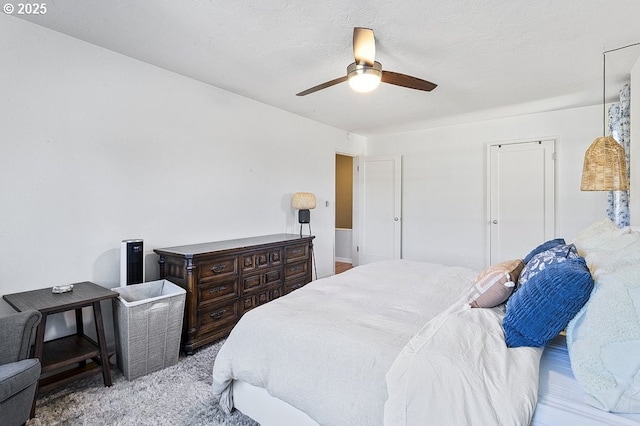 bedroom featuring ceiling fan and light carpet