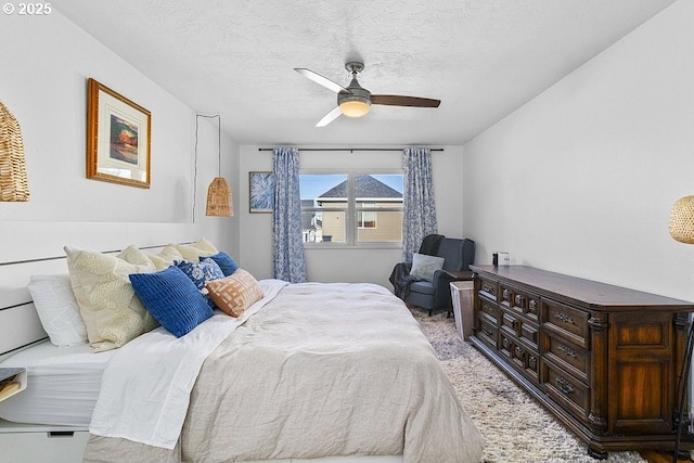 bedroom with a textured ceiling and ceiling fan