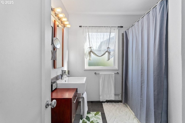 bathroom with tile patterned flooring, a shower with curtain, and sink