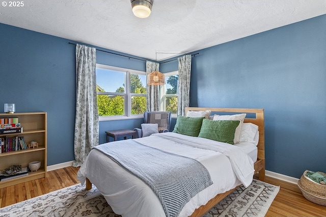 bedroom featuring hardwood / wood-style floors and a textured ceiling