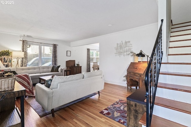 living room featuring hardwood / wood-style flooring and crown molding