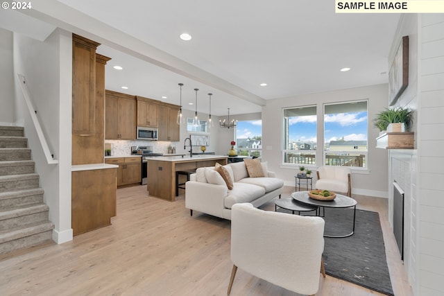 living room with light hardwood / wood-style floors and an inviting chandelier