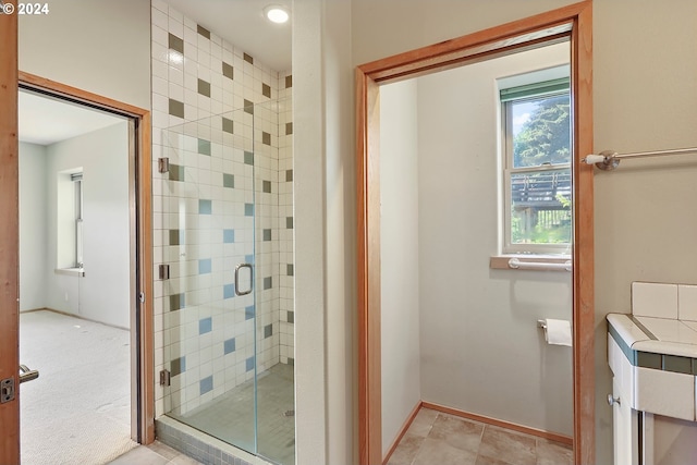 bathroom featuring a shower with shower door