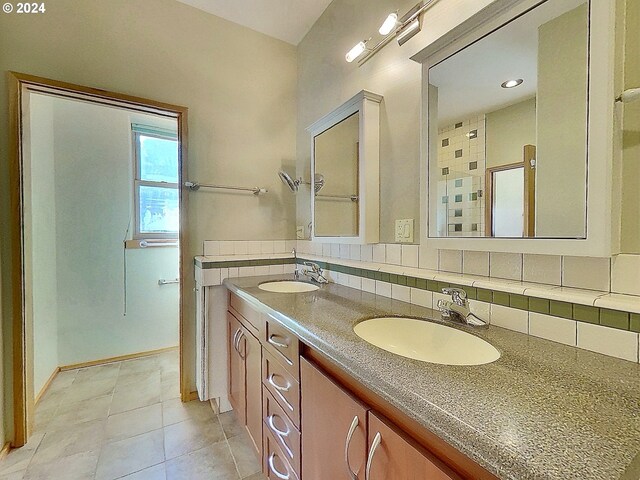 bathroom featuring vanity, backsplash, and tile patterned flooring