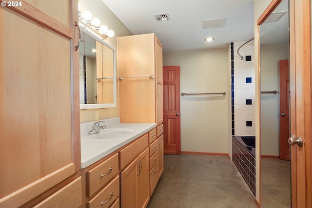 bathroom featuring vanity, shower / bath combination, and concrete floors