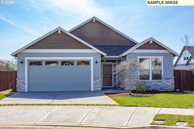 craftsman inspired home with a front lawn and a garage