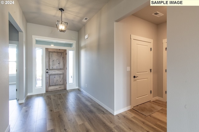 entryway with hardwood / wood-style flooring