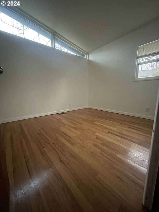 13815 NE Knott St, Portland, OR 97230 - empty room with wood finished floors and lofted ceiling