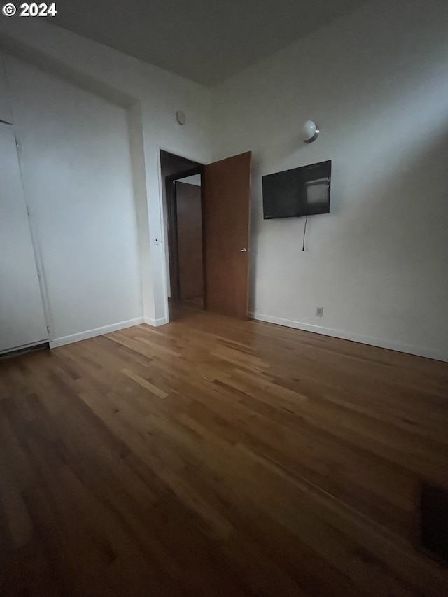 unfurnished room featuring dark hardwood / wood-style flooring