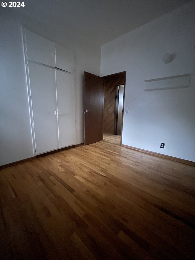 13815 NE Knott St, Portland, OR 97230 - unfurnished bedroom with light wood finished floors and a closet