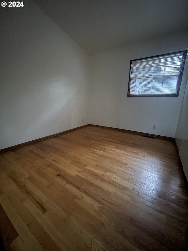 spare room featuring light hardwood / wood-style floors