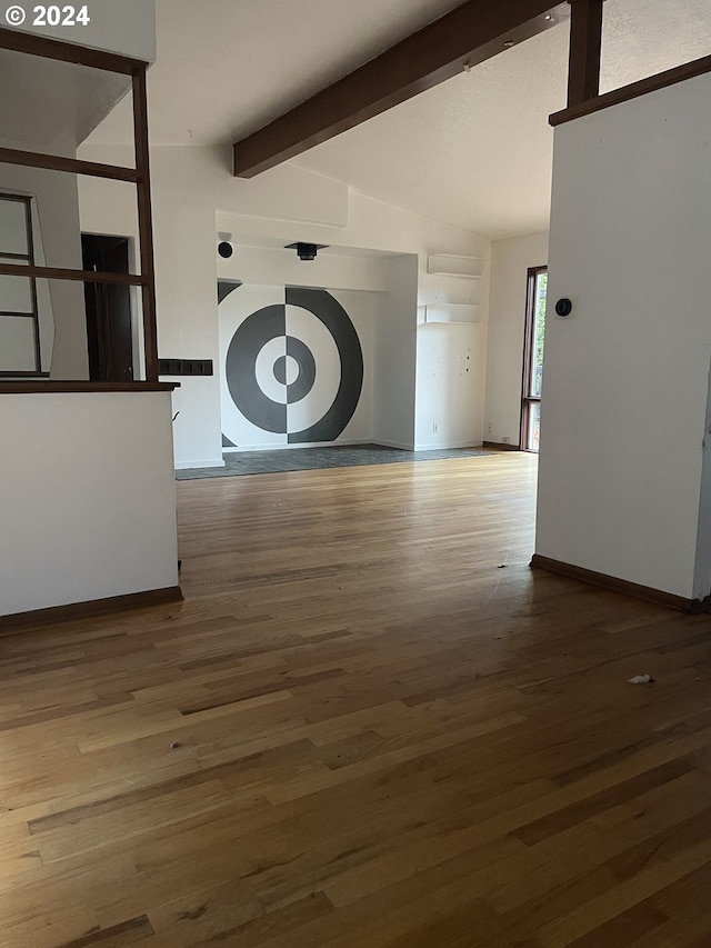 interior space featuring vaulted ceiling with beams and hardwood / wood-style floors