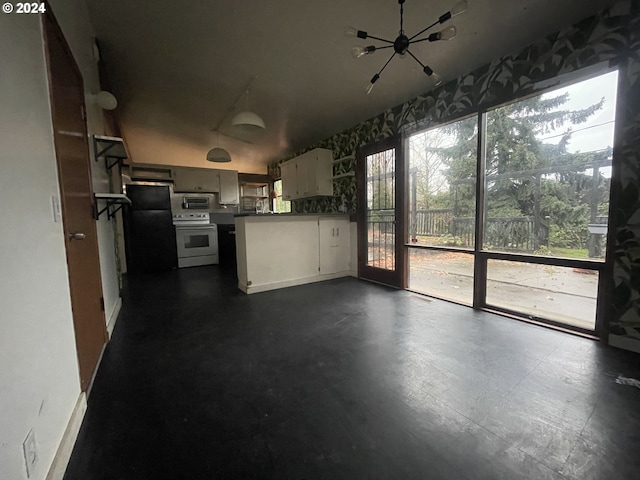 13815 NE Knott St, Portland, OR 97230 - kitchen featuring white range with electric cooktop, stainless steel microwave, a chandelier, and freestanding refrigerator