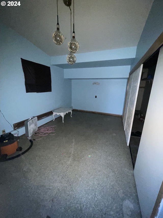 unfurnished living room with concrete flooring and vaulted ceiling