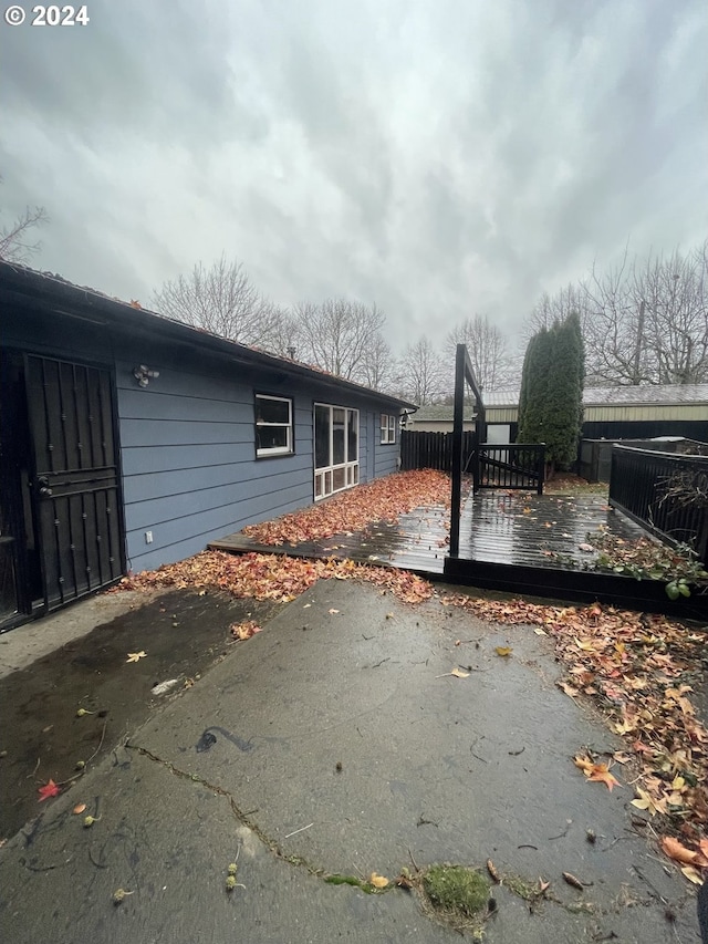 view of home's exterior with a patio area and a deck